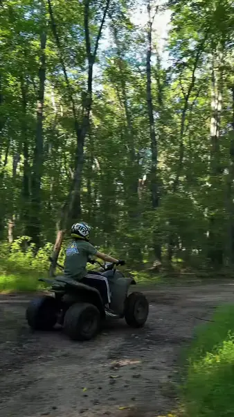 ATV riders on a tree-lined trail at NJ ATV Rentals