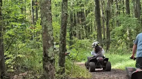 Riders on a wooded ATV trail at NJ ATV Rentals